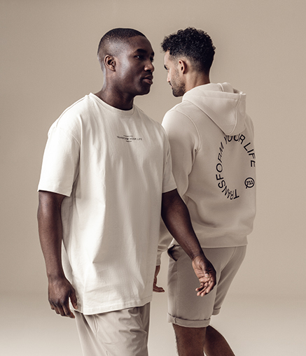 Two men in premium activewear for a bring-a-friend gym offer